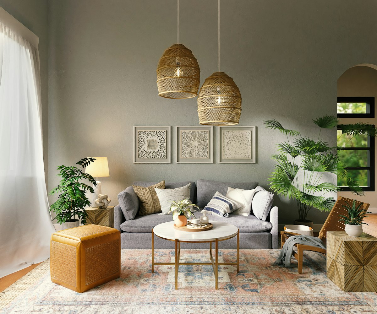 Styled living room with woven pendant lights, a grey sofa and framed botanical prints