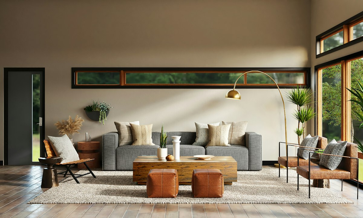 Warm living room with a low beige sofa, terracotta cushions and tall indoor plants