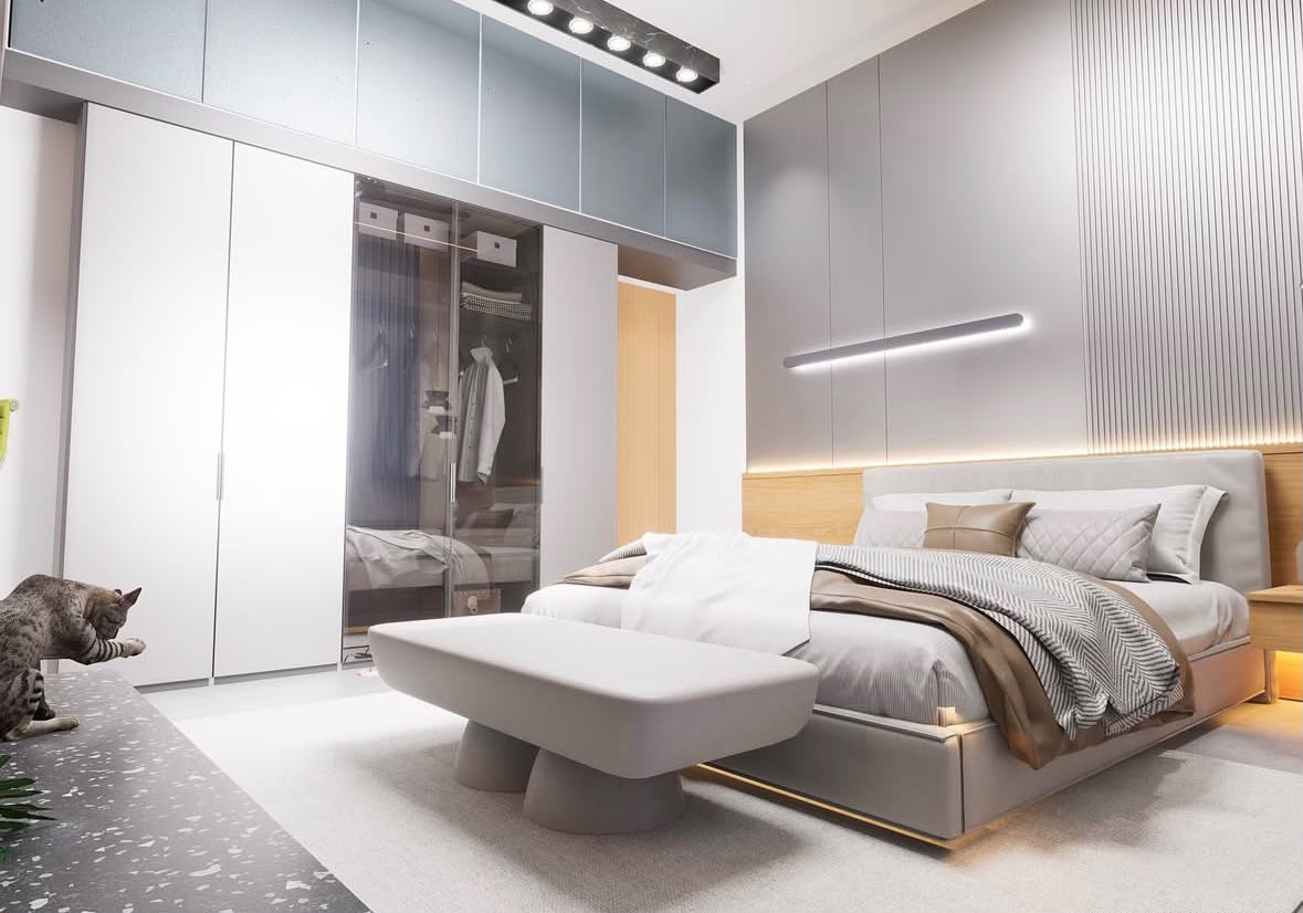 Bedroom with a glass-front wardrobe, grey fluted wall panels and an upholstered bed with cove lighting